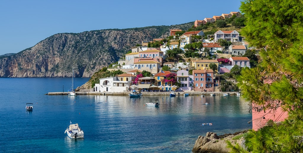 Traditional Greek villas nestled between the hills and waterfront in teh village of Assos, Kefalonia