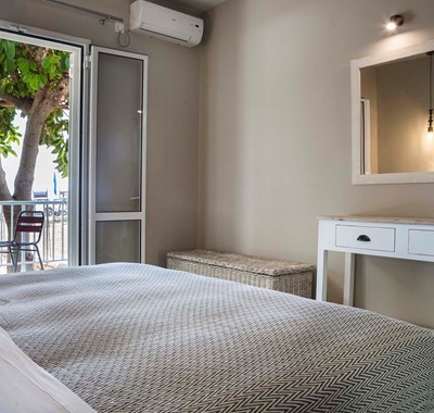 Bedroom with outside seating and air conditioning Beachfront Suite No1, Lourdata, Kefalonia