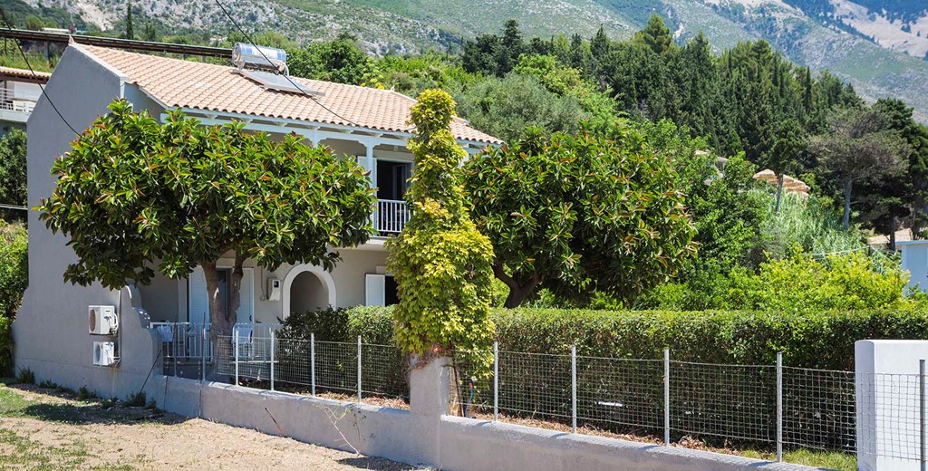 Lush green gardens and planting with the mountains as a backdrop at Beachfront Suites, Lourdata, Kefalonia