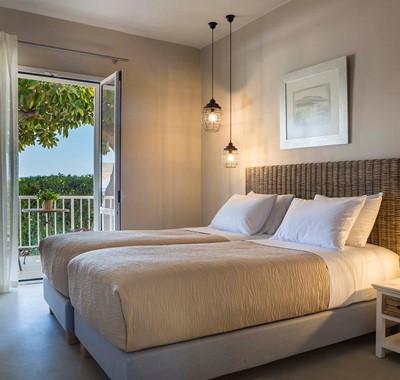 Bedroom and French doors opening onto sea views inside Beachfront Suite No2, Lourdata, Kefalonia