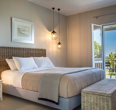 Double bed and French doors onto the balcony with views of the sea at Beachfront Suite No3, Lourdata, Kefalonia