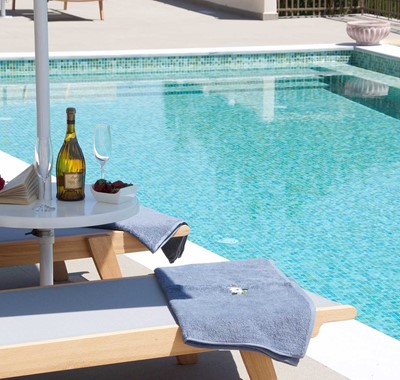 Reading and wine by the pool makes a relaxing holiday in Magnolia Apartments, Fiscardo, Kefalonia, Greek Islands
