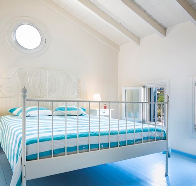 Clean bright open relaxed bedroom with double bed inside Thalassa House, Assos, Kefalonia, Greek Islands