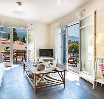 French doors lead to the balcony from the lounge space inside Thalassa House, Assos, Kefalonia, Greek Islands