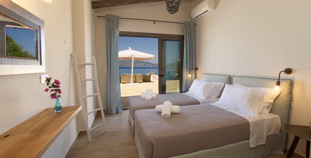 Bedroom with a view, twin beds and wide opening doors inside Villa Frydi, Karavomilos, Kefalonia, Greek Islands