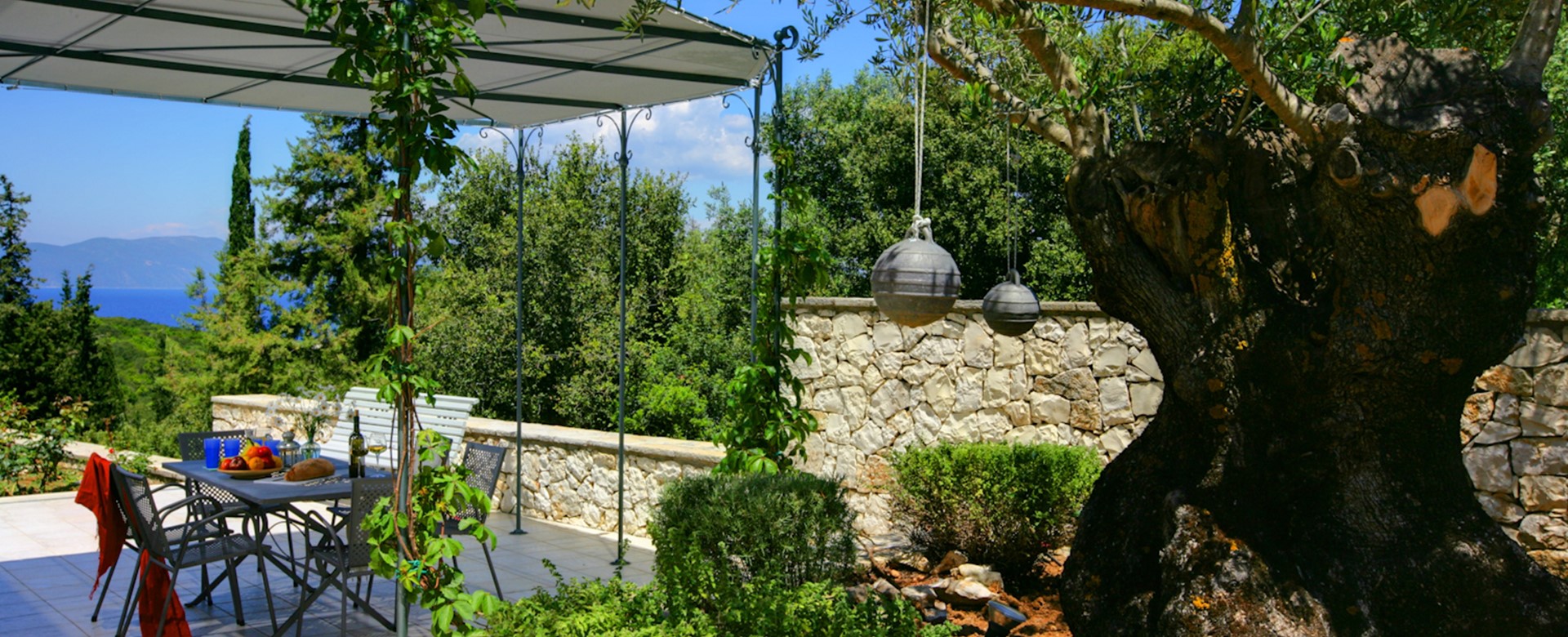 Eat alfresco on the shady terrace at Villa Gaeta Fiscardo, Kefalonia, Greek Islands