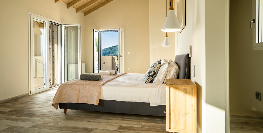 Wake up to double aspect views in a light and airy bedroom at Villa Gionis Fiscardo, Kefalonia, Greek Islands