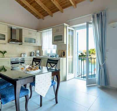 Full equipped kitchen diner with French doors to terrace at Villa Petrino, Assos, Kefalonia, Greek Islands