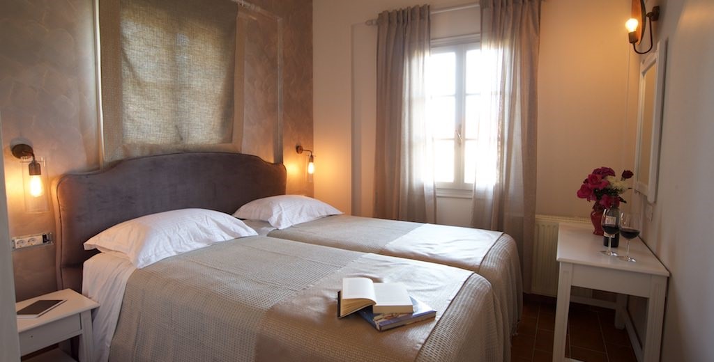 Large beds and subtle lighting inside Magnolia Apartments, Fiscardo, Kefalonia, Greek Islands