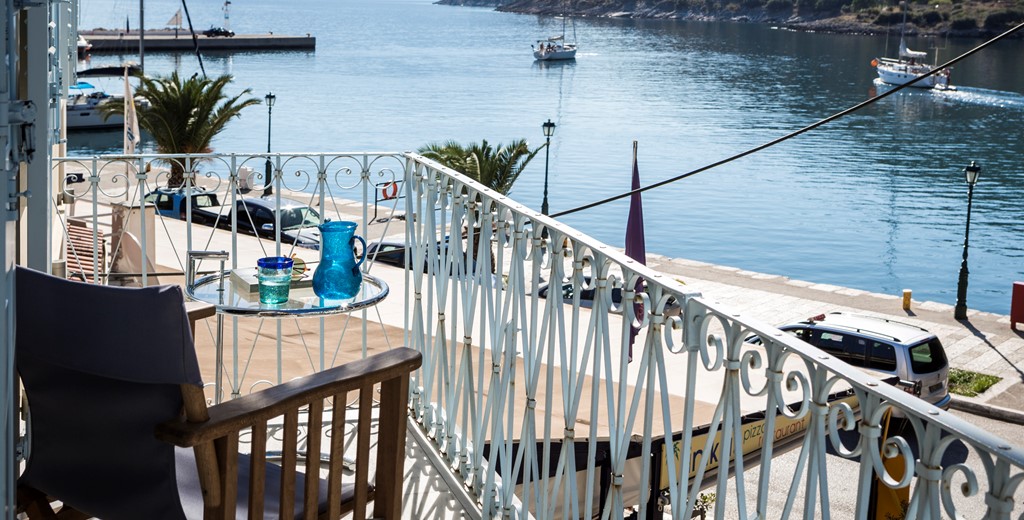 Watch the yachts and boats go out to sea in the morning while enjoying a morning coffee on the balcony of Palm House Harbourfront Mansion, Agia Efimia, Kefalonia, Greek Islands